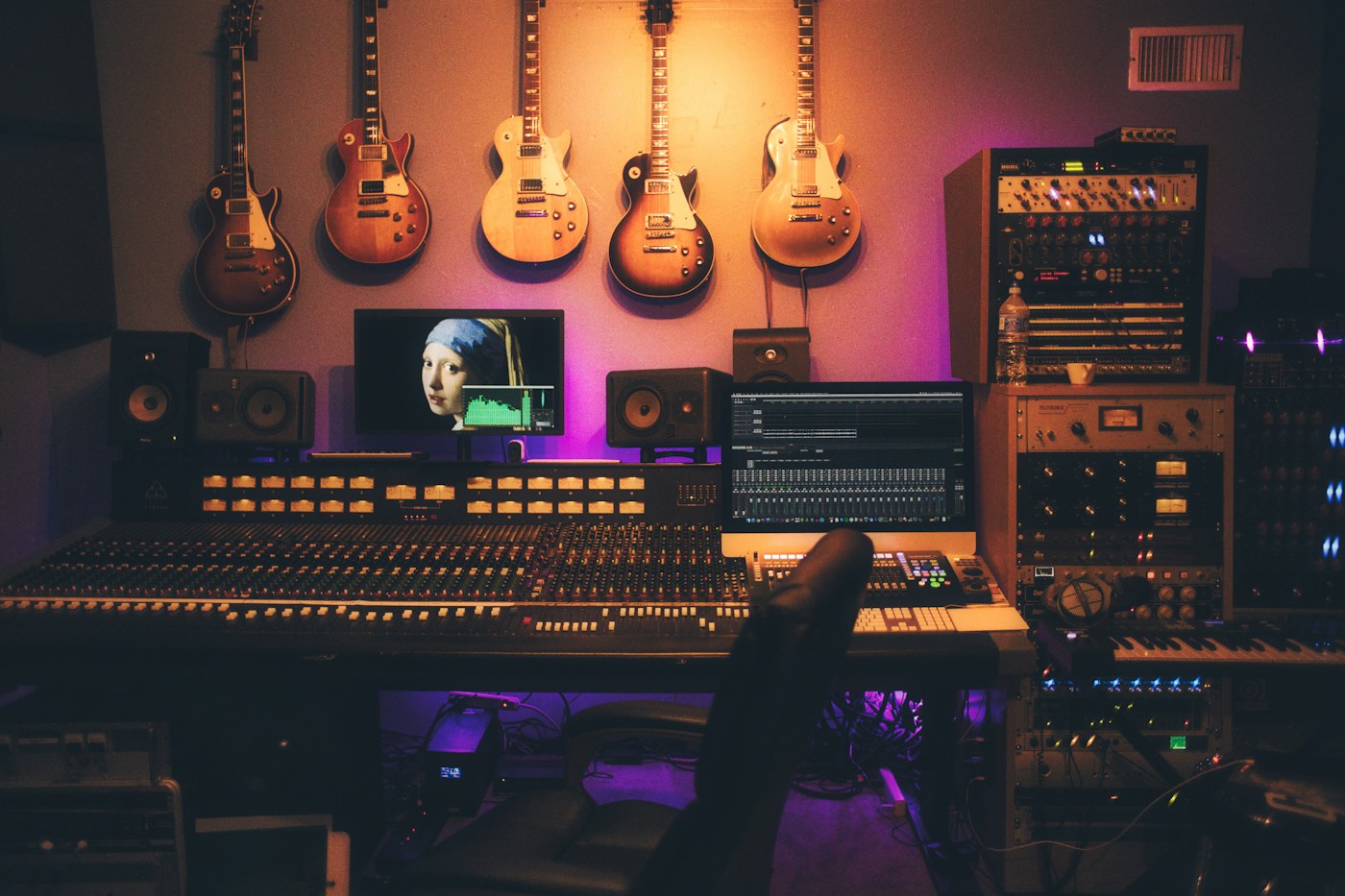 Microphones, instruments, and a mixing desk in a recording studio